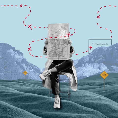 person sitting in a chair reading a road map