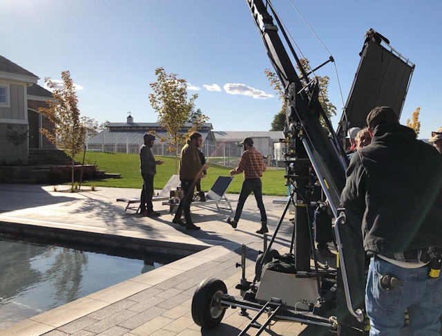 behind the scenes view of a backyard pool with a Belgard surround
