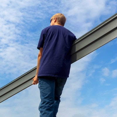 man carrying long piece of vinyl siding