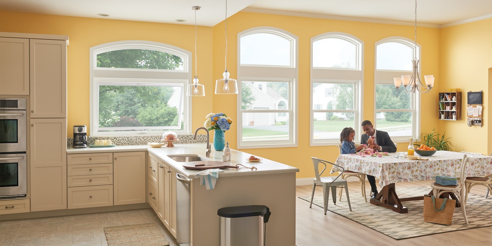 man and child sitting in kitchen with miter windows