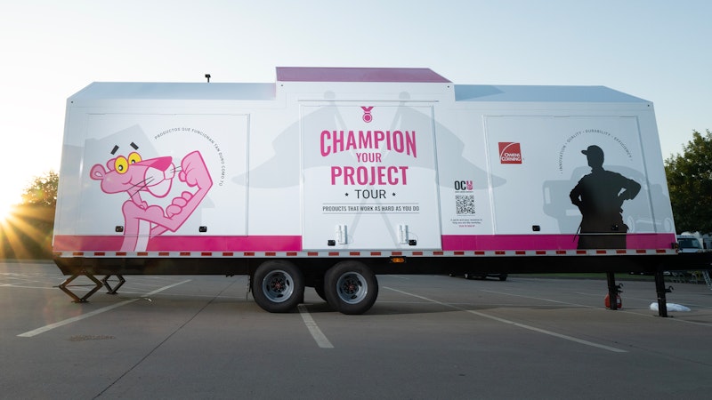 Owens Corning Insulation road show trailer sitting in a parking lot all closed up