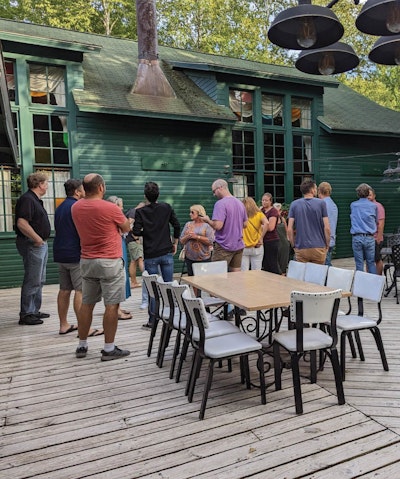 Interrupt employees gathering on restaurant patio before dinner