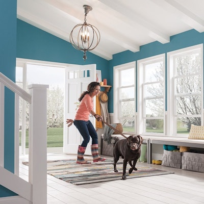women with dog on a leash entering home foyer with MI windows