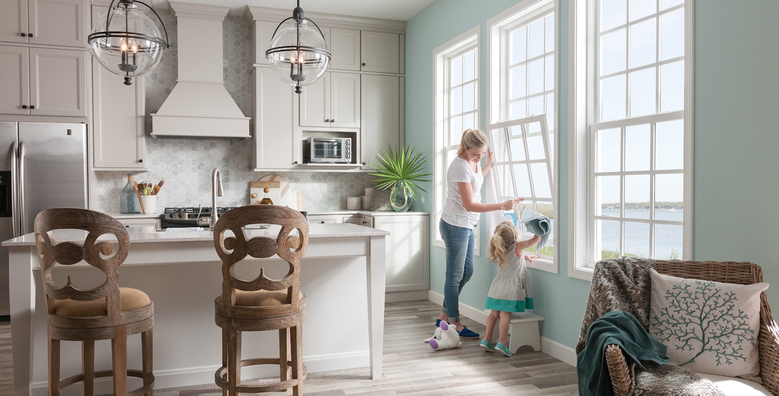 mother and child in kitchen washing a miter window