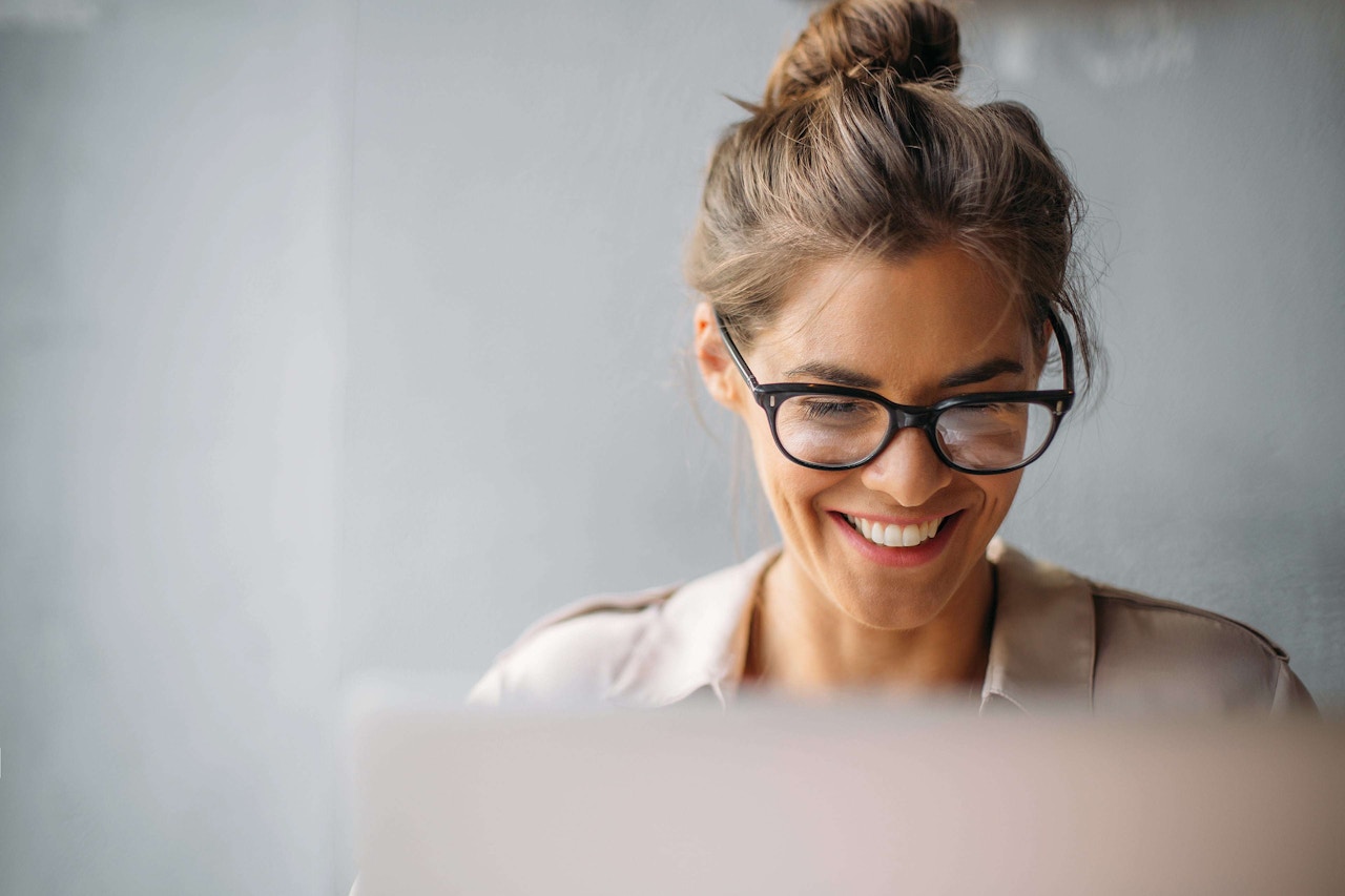 smiling woman working at laptop