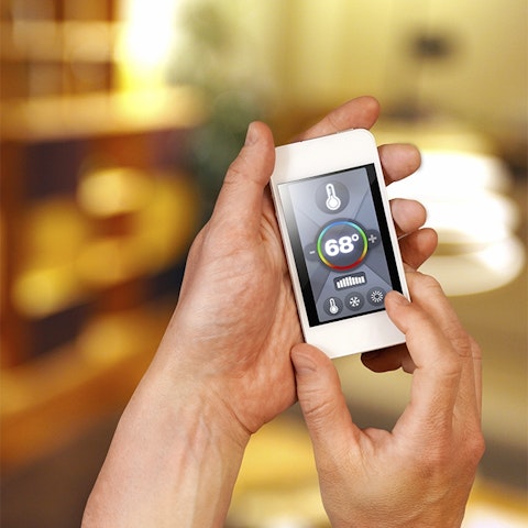 hands holding a phone with temperature app displayed