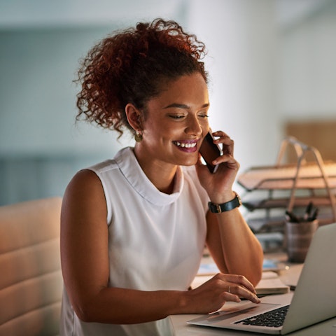 woman working at laptop and on the phone