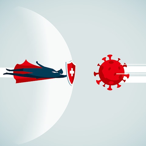super hero with cape and shield protecting against a large virus bug