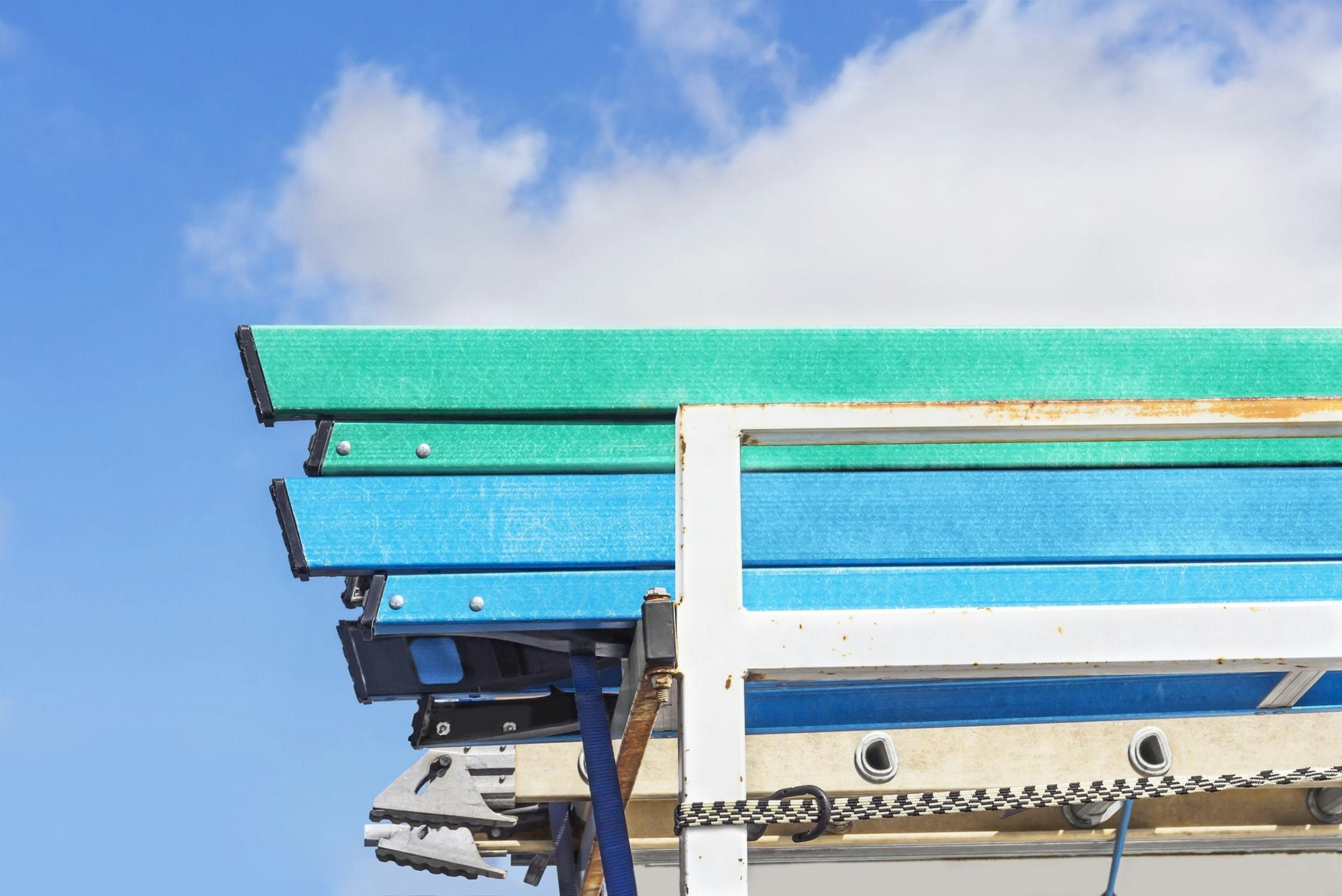 close up view of the back of a truck loaded with ladders