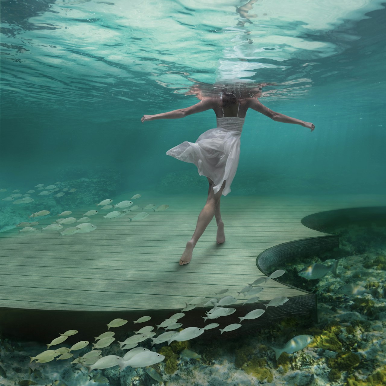 girl in water walking away on moistureshield deck that is also underwater